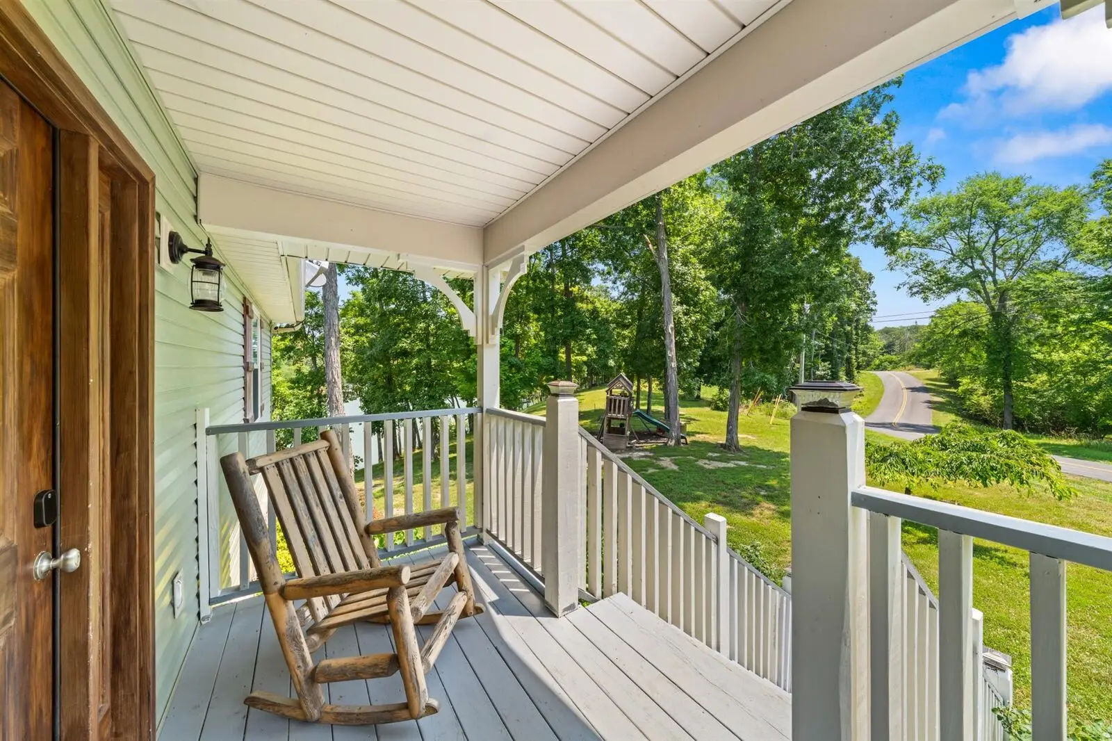 Rocking chairs on the covered front porch looking out over the lawn