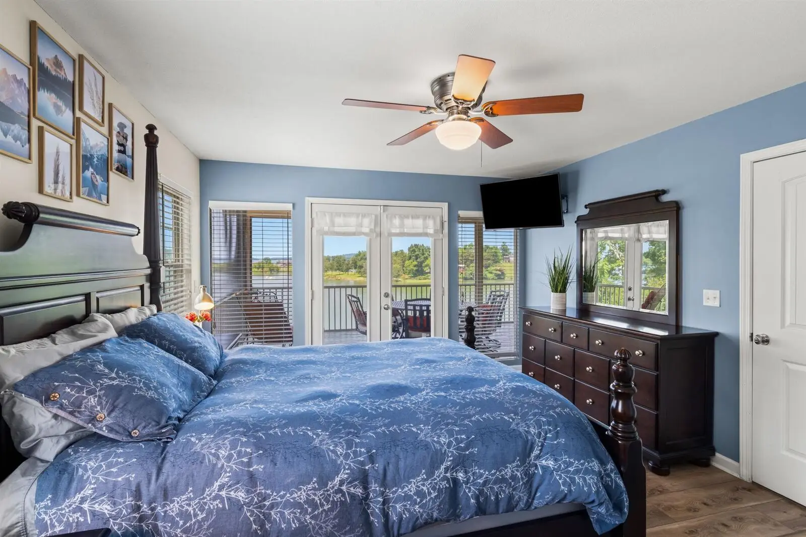The second main-level bedroom from the doorway, queen bed with french doors onto the porch