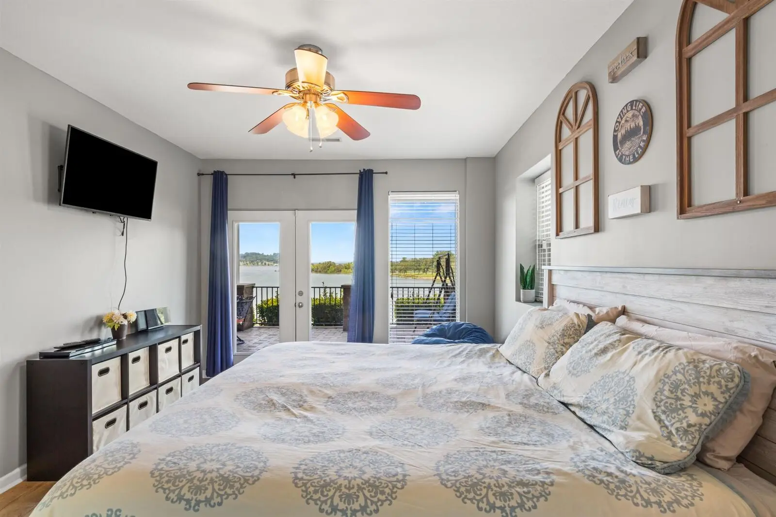 The lower-level king bedroom from the opposite corner, with its own walkout to the lake