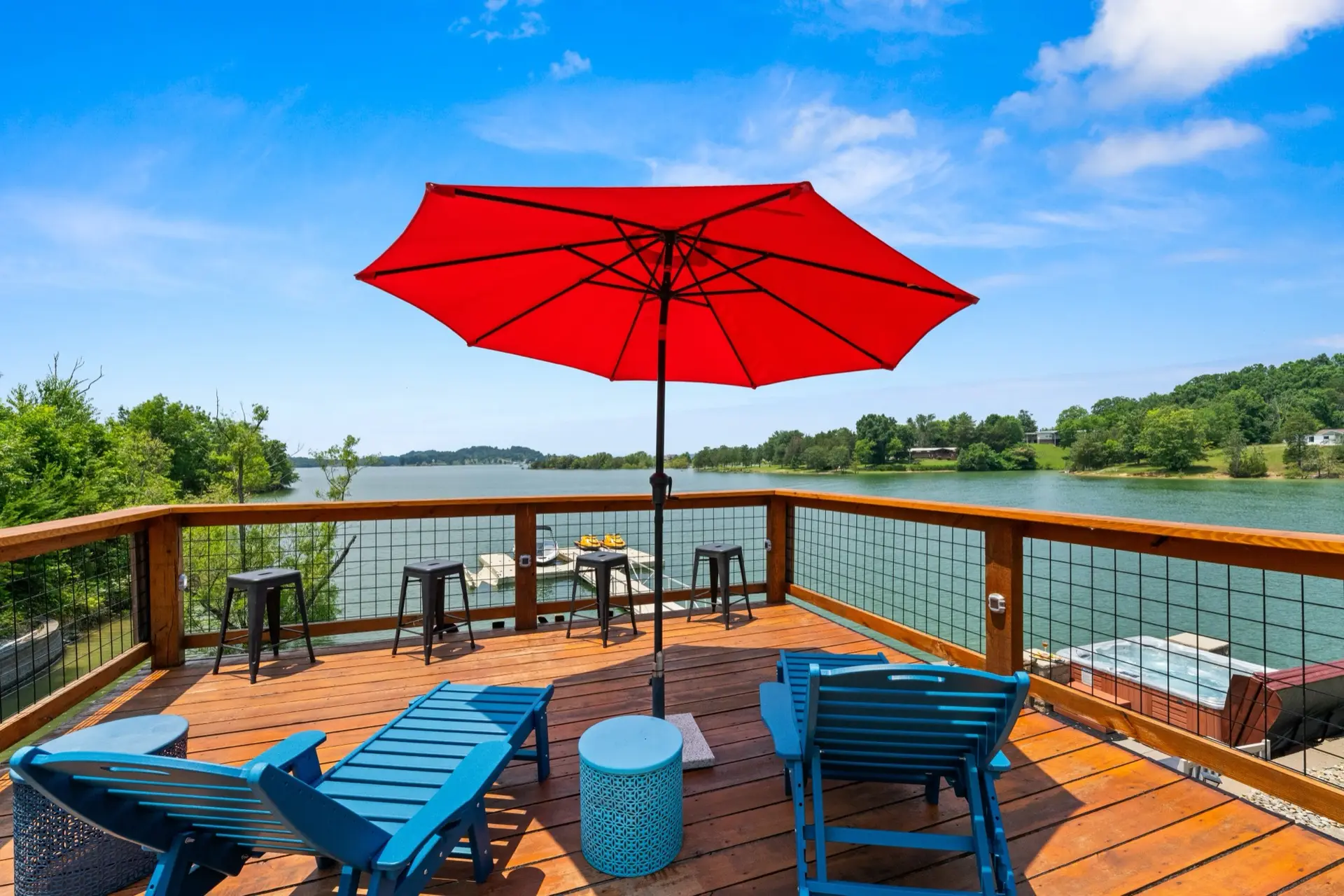 Red umbrella and blue lounge chairs on the lakeside sundeck overlooking Douglas Lake