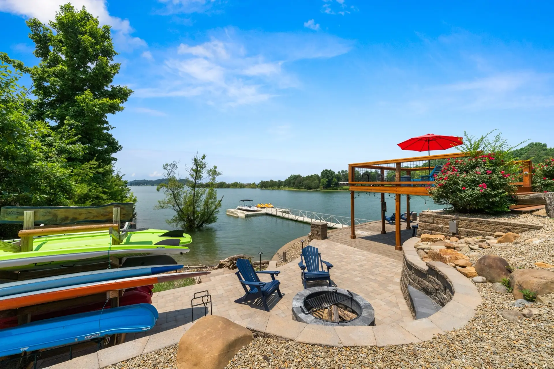 The waterside hardscape with sunken firepit, kayak rack, pavilion, and sundeck at the edge of Douglas Lake