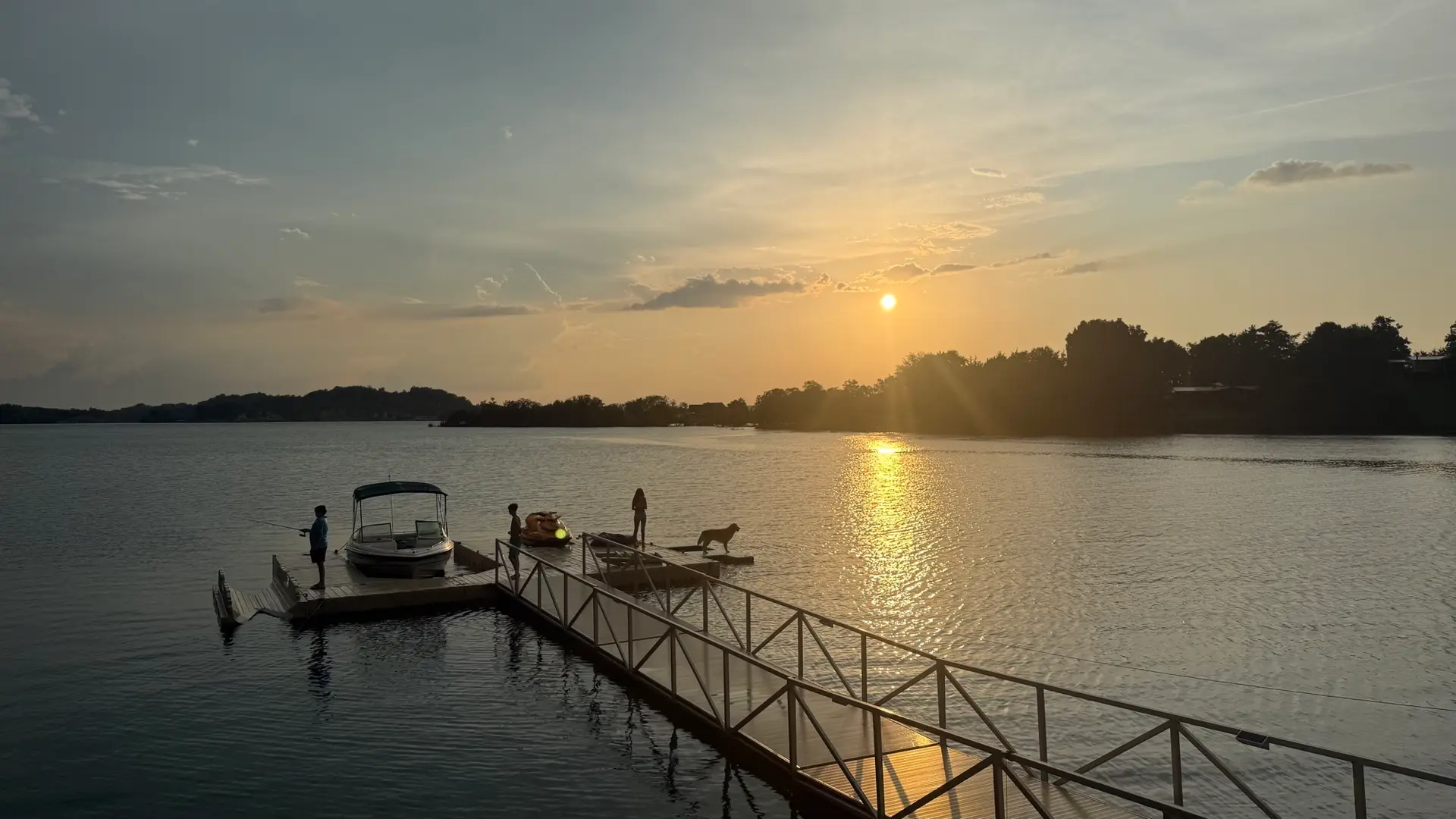 Family enjoying the floating dock at golden hour on Douglas Lake