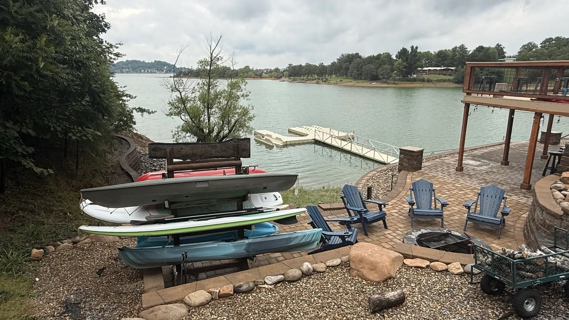 The kayak and paddle board rack on the hardscape overlooking a still, quiet Douglas Lake
