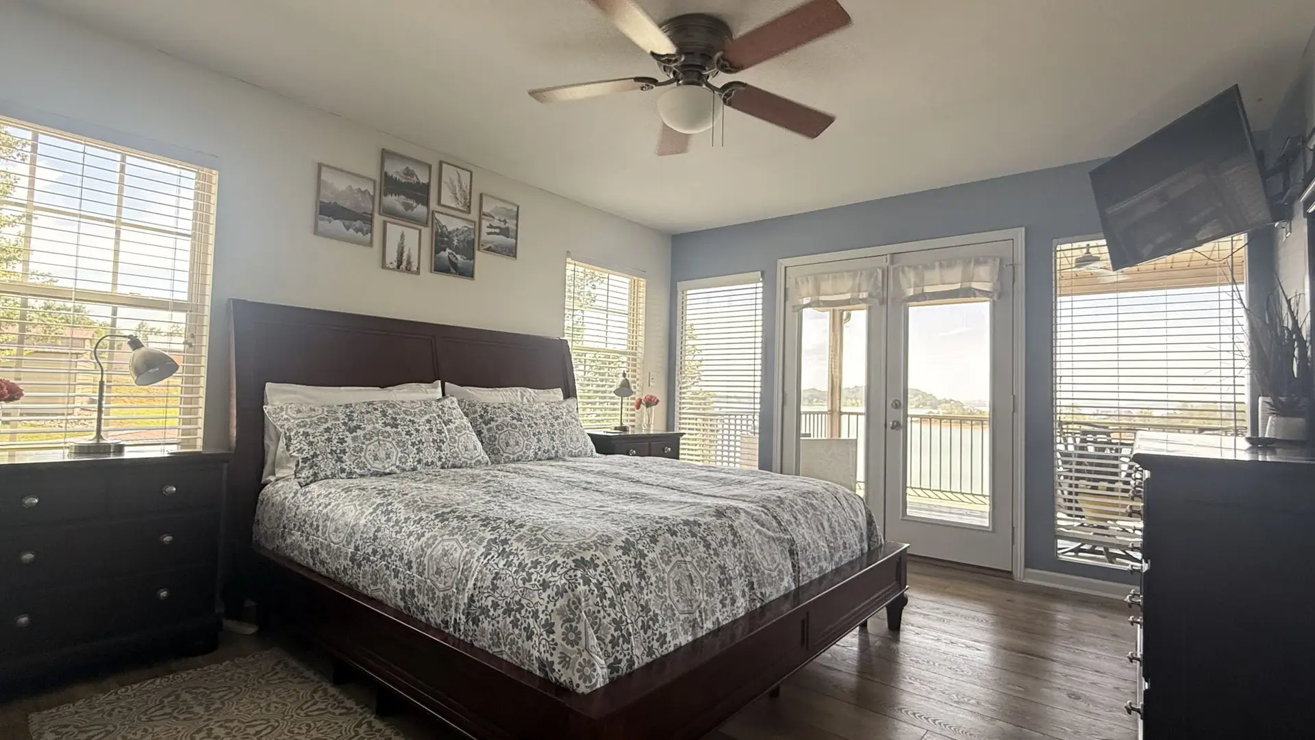 Main-level king bedroom with French doors opening to the porch and Douglas Lake