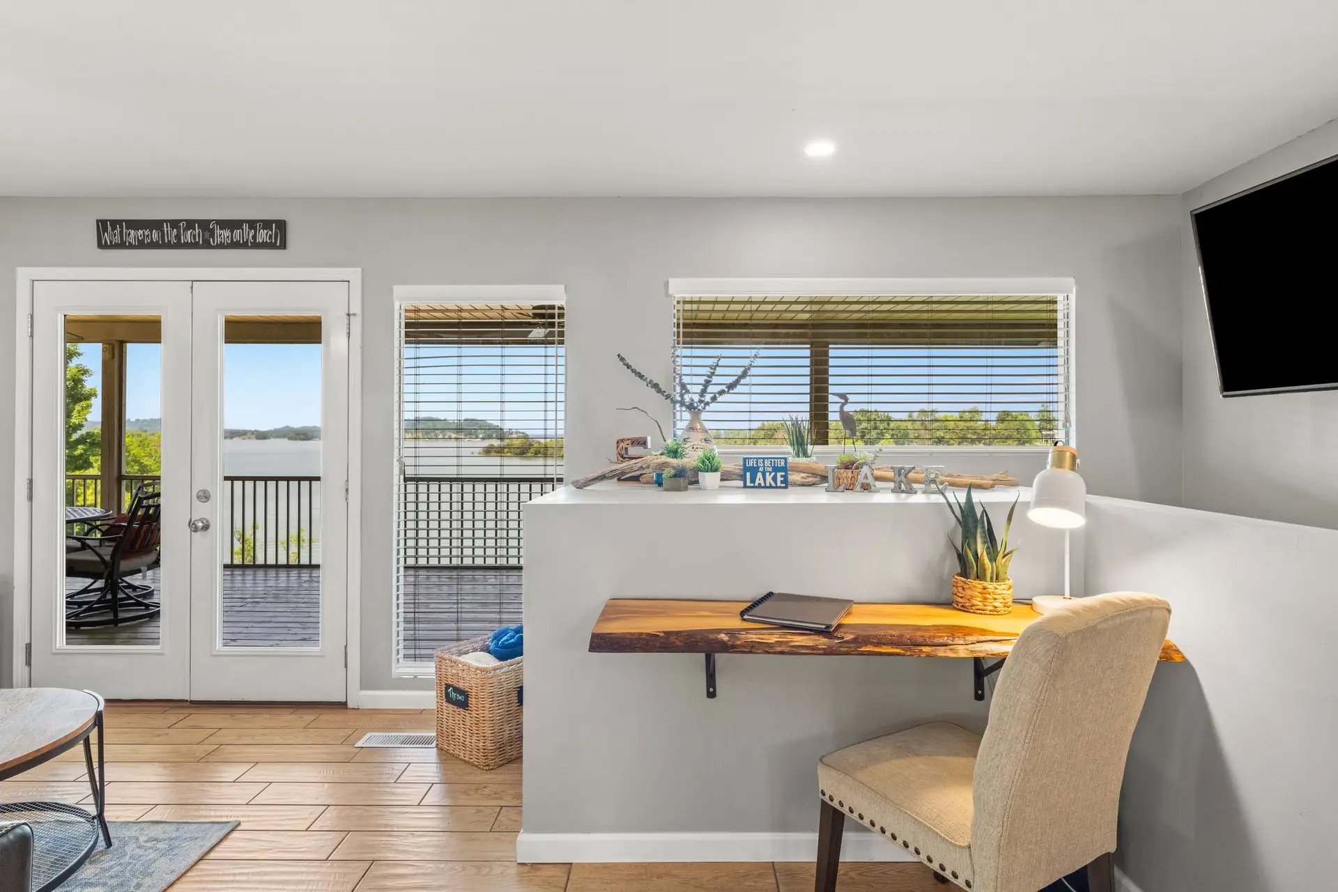 Dedicated workspace with a live-edge desk beside French doors overlooking Douglas Lake