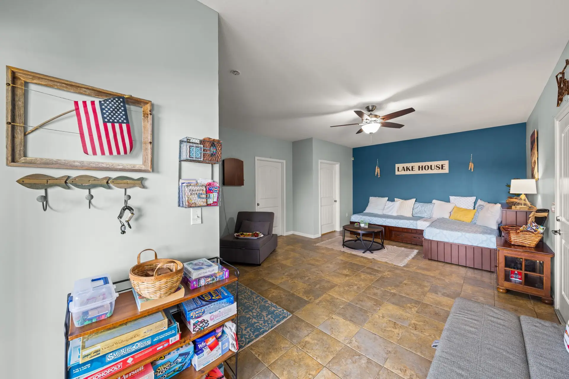 Shelves of board games beside the twin day beds in the rec room