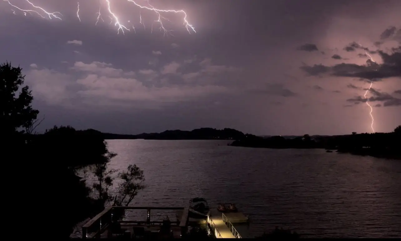 Lightning strikes over Douglas Lake beyond the floating dock